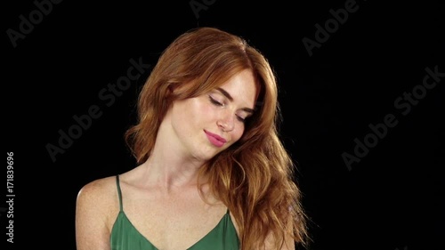 Girl genuinely smile at the camera. Black background. Slow motion
