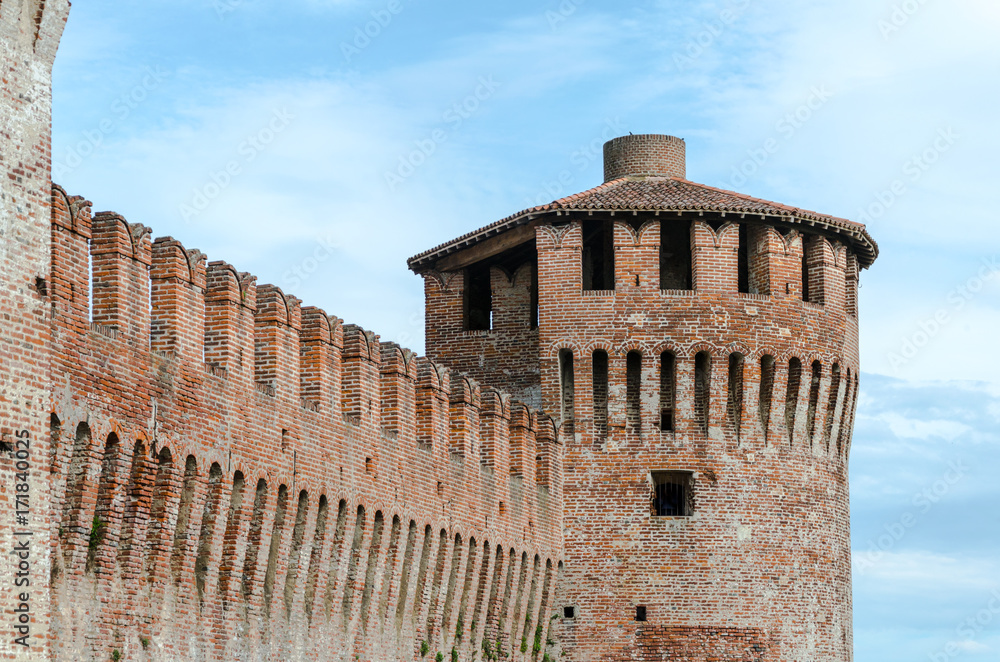 An ancient medieval italian fortress stands in the sky
