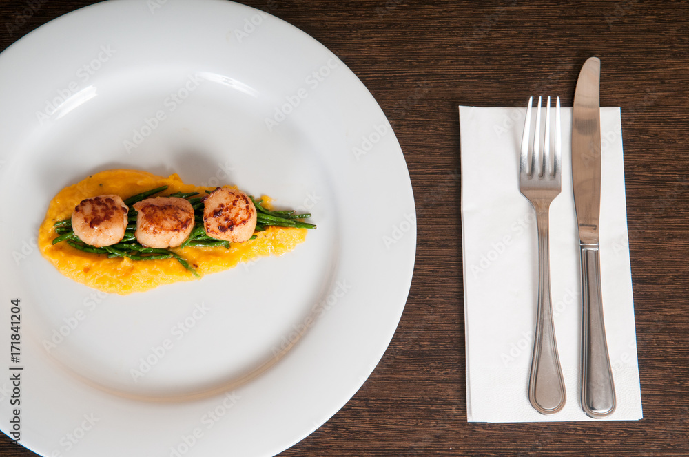 gourmet seafood dish of scallops and asparagus on a white plate gourmet seafood dish of scallops and asparagus on a white plate