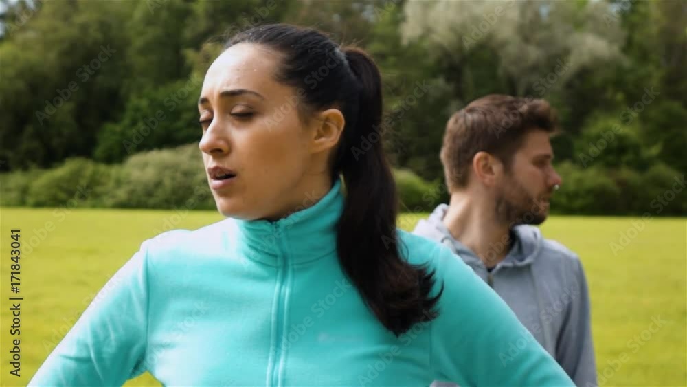 Sport couple relaxing after jogging. Woman and man runner training. Healthy active lifestyle concept. Epic turning looking eyes at camera. Female at front view. Super slow moion shot. Sport couple relaxing after jogging. Woman and man runner training. Healthy active lifestyle concept. Epic turning looking eyes at camera. Female at front view. Super slow moion shot.