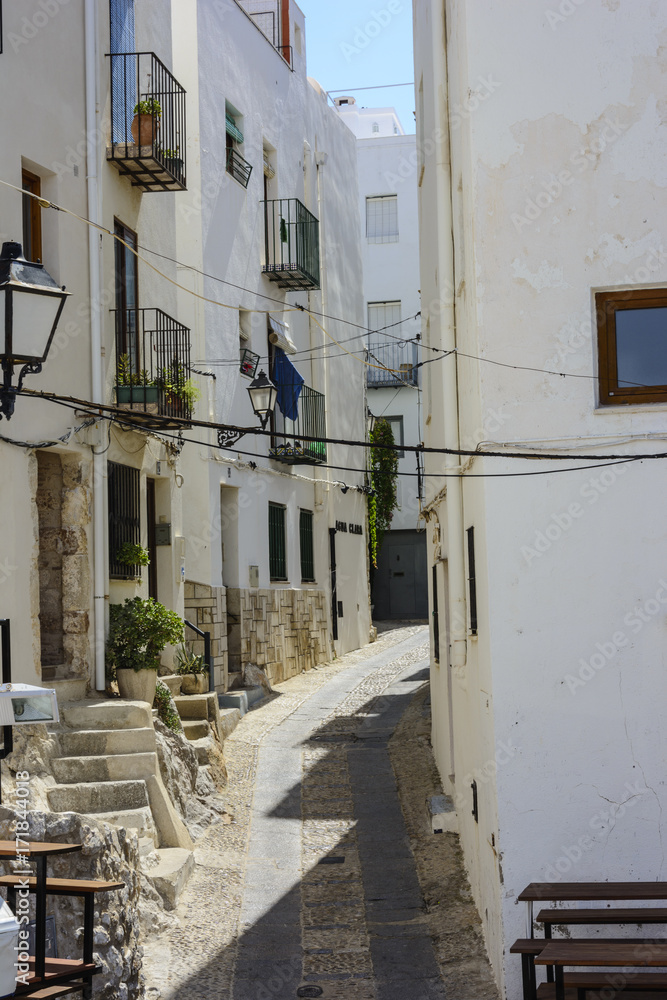 Fototapeta premium Cobbled and narrow street in the tourist town of Peñiscola.