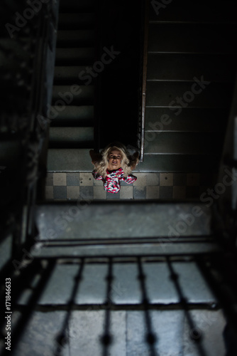 beautiful blonde poses near old windows in a building