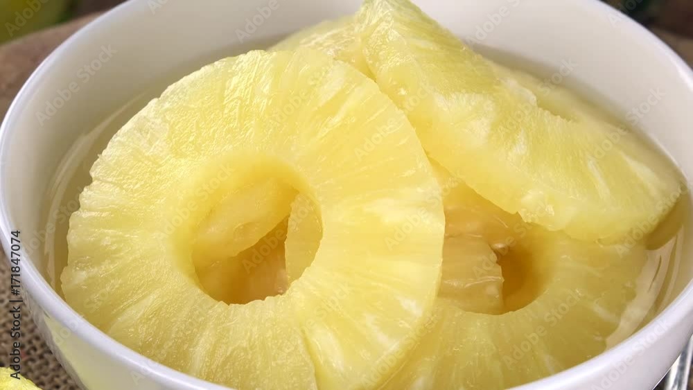 Chopped Pineapple (preserved) rotating on a wooden plate (not loopable; 4K) Chopped Pineapple (preserved) rotating on a wooden plate (not loopable; 4K)