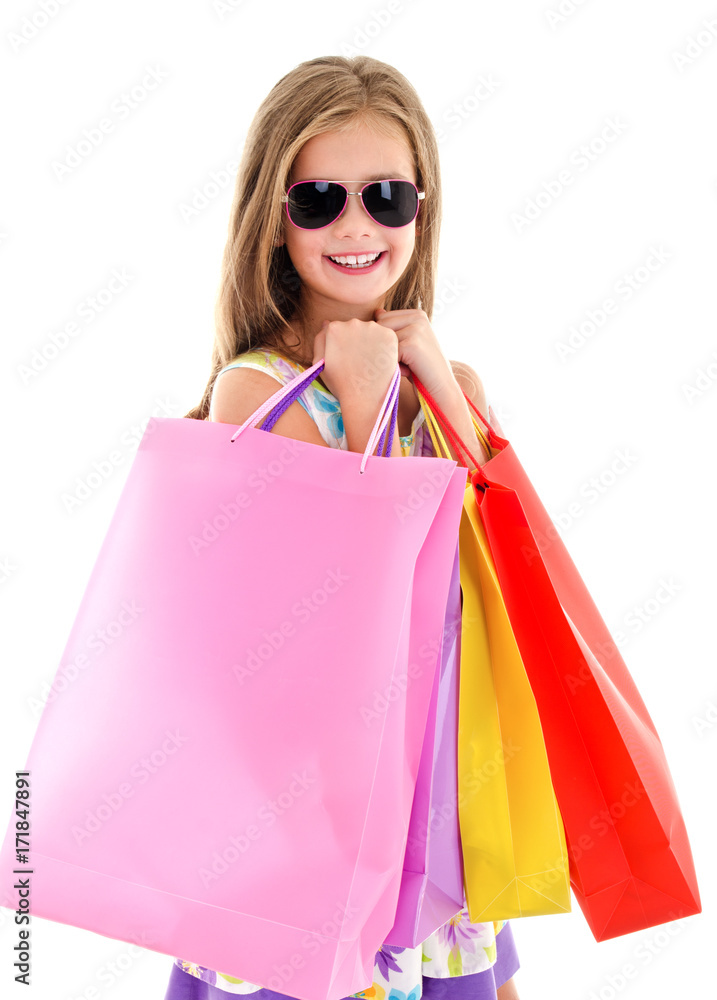 Adorable little girl child in sunglasses holding shopping colorful paper bags Adorable little girl child in sunglasses holding shopping colorful paper bags