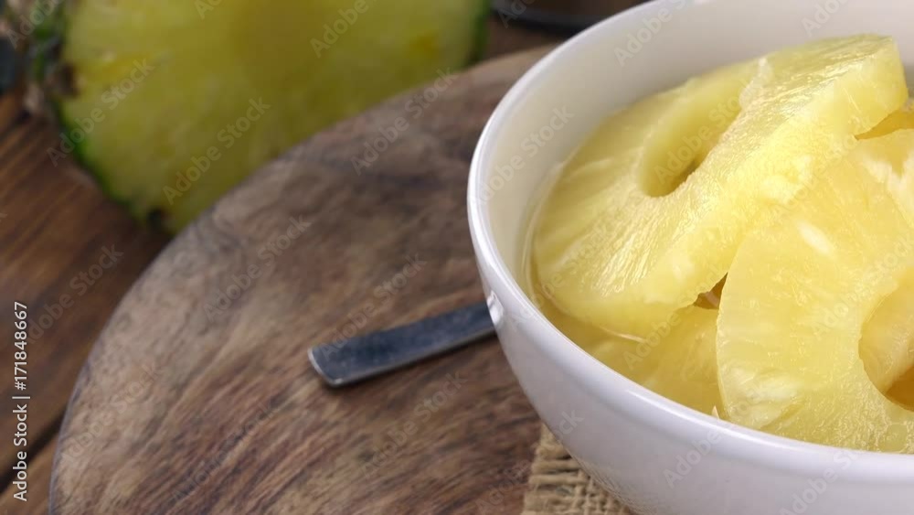 Portion of Preserved Pineapple pieces rotating on a wooden plate (not loopale; 4K) Portion of Preserved Pineapple pieces rotating on a wooden plate (not loopale; 4K)