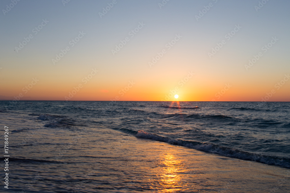colorful sunset on the background of the sea and waves