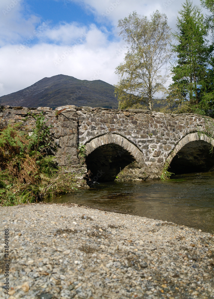 A medieval stone bridge in the british countryside. English historical history Heritage.