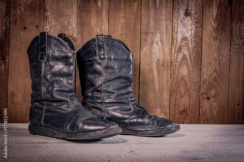 Old leather boots on dirt wooden background   © serejkakovalev