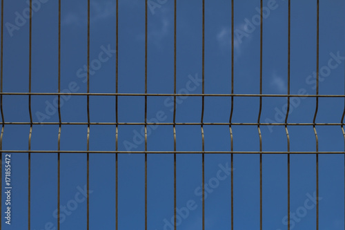 Wallpaper Mural close up picture of cage fence against blue sky   Torontodigital.ca