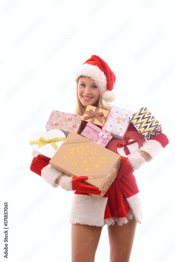 A young girl dressed in a Santa Claus suit has lots of Christmas presents gathered in her arms. Smiling, she stands in front of a white background. A young girl dressed in a Santa Claus suit has lots of Christmas presents gathered in her arms. Smiling, she stands in front of a white background.