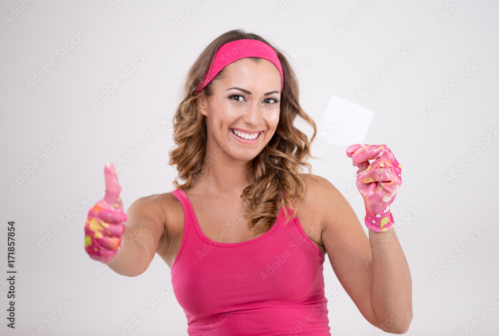 Happy woman in cleaning outfit holding a piece of paper Happy woman in cleaning outfit holding a piece of paper