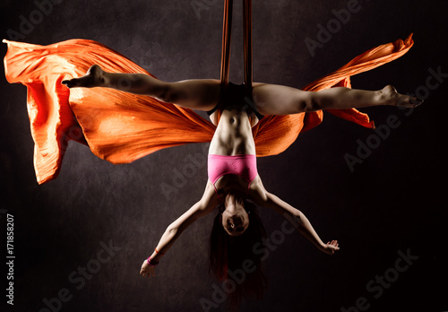 Fototapeta Naklejka Na Ścianę i Meble -  Beautiful sexy dancer on aerial silk, graceful contortion, acrobat performs a trick on a ribbons