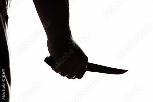 Stabbing attack. Hand with a knife. Murder with a knife.