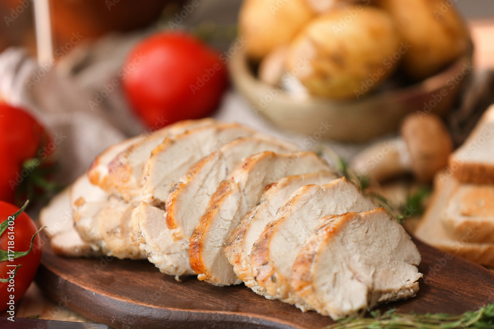 Delicious sliced turkey breast on wooden board Delicious sliced turkey breast on wooden board