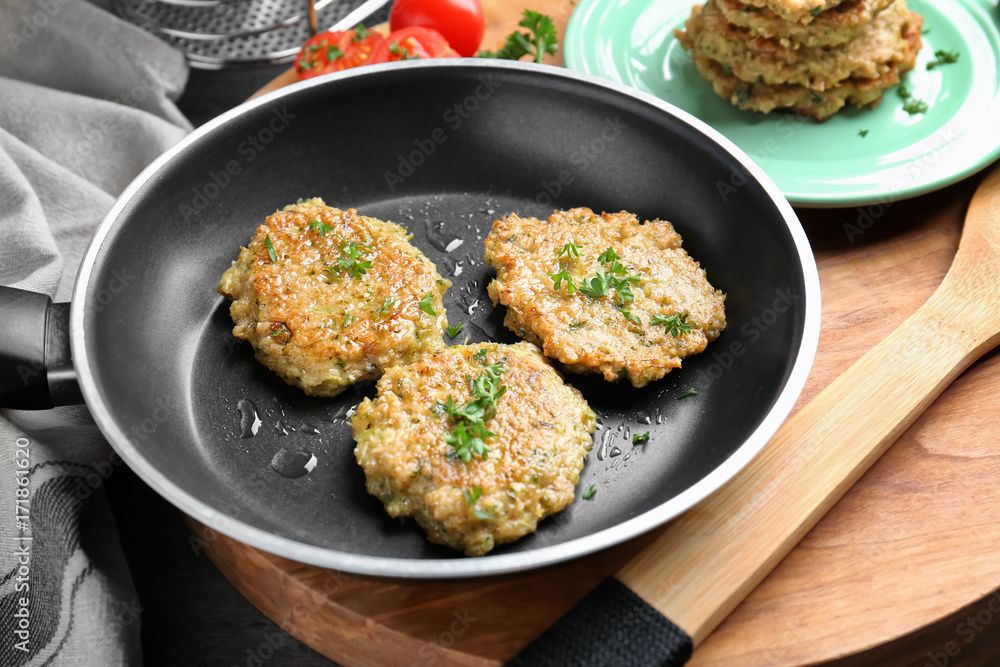 Delicious broccoli pancakes on frying pan in kitchen Delicious broccoli pancakes on frying pan in kitchen