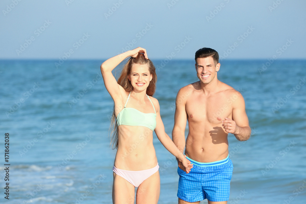 Happy young couple on sea beach Happy young couple on sea beach