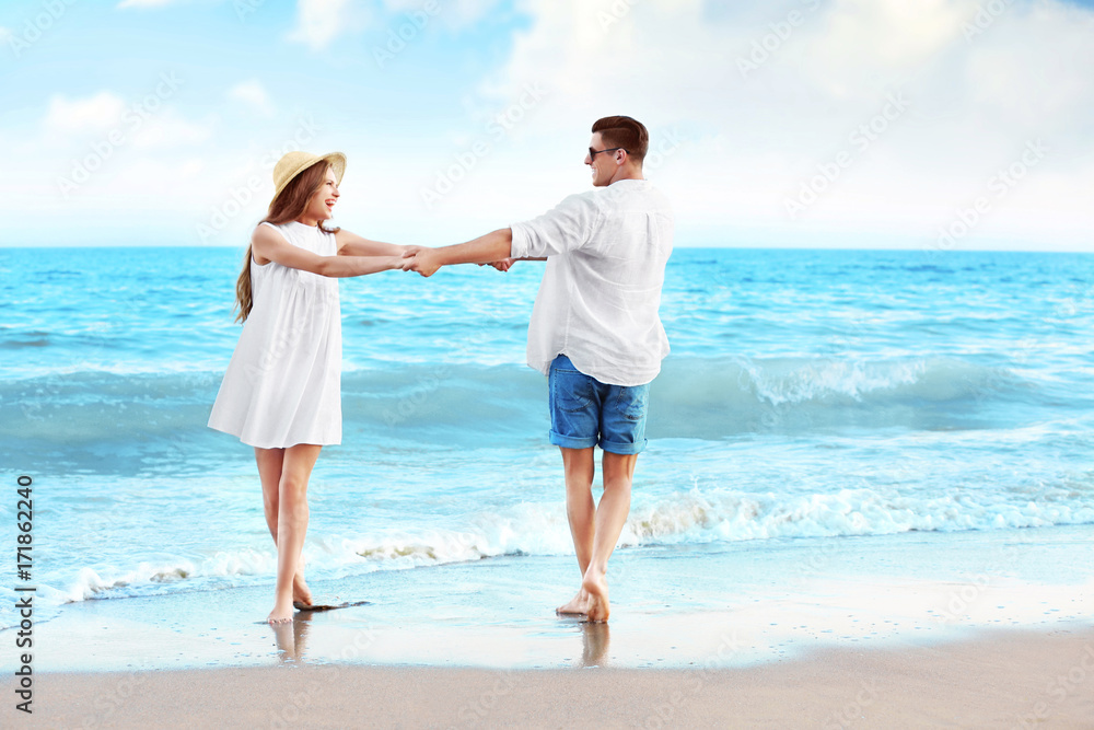 Happy young couple on sea beach