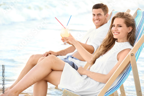 Happy young couple drinking...