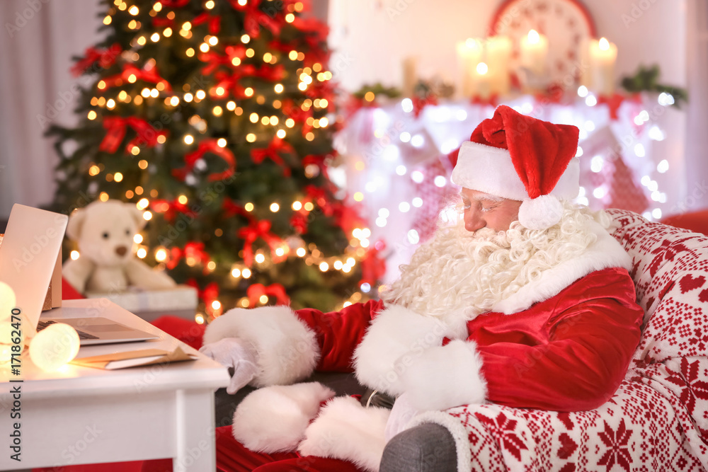 Authentic Santa Claus sleeping in armchair at room decorated for Christmas Authentic Santa Claus sleeping in armchair at room decorated for Christmas