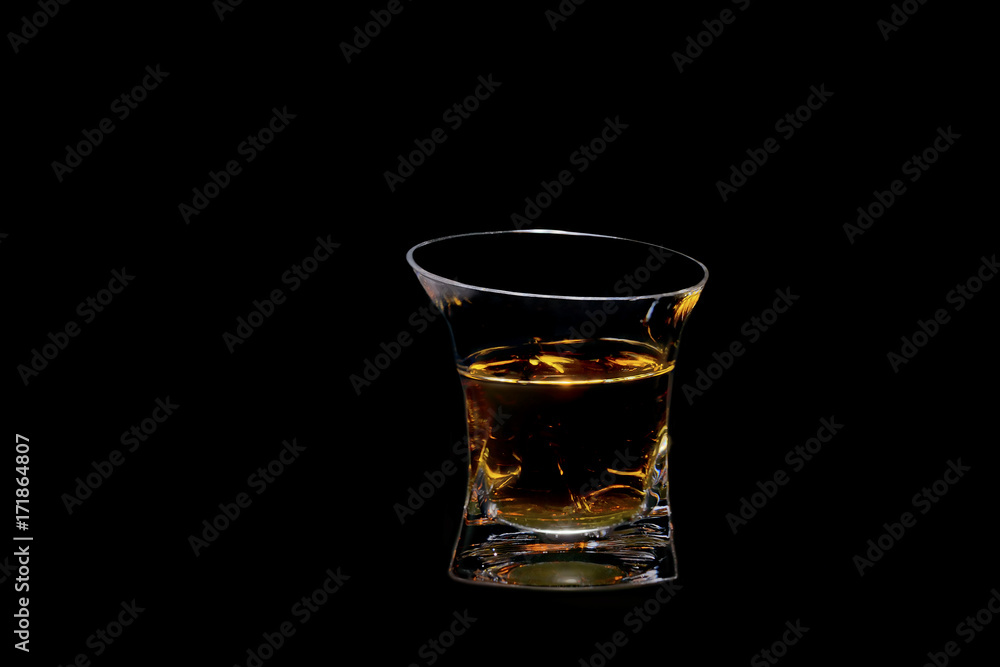 glass beaker filled with a beautiful alcoholic drink, on a black background glass beaker filled with a beautiful alcoholic drink, on a black background