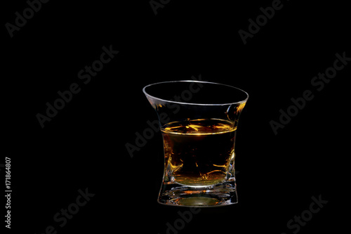 glass beaker filled with a beautiful alcoholic drink, on a black background