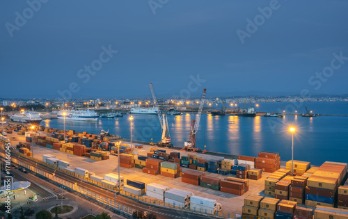 Albania. Durres. View from above to the port of Durres in the Adriatic Sea. A platform for containers surrounded by tower cranes for unloading. In the port there are tankers for cargo transportation photo