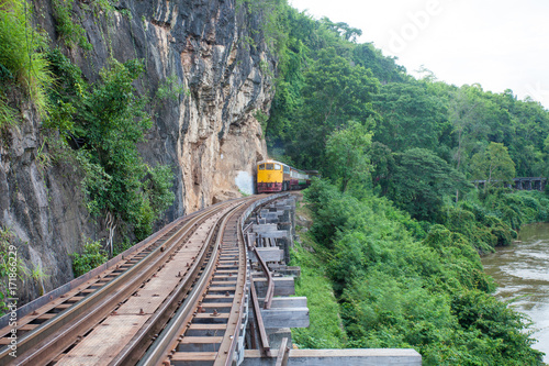 Train in the mountains. Railway among the rocks with a beautiful nature and trees