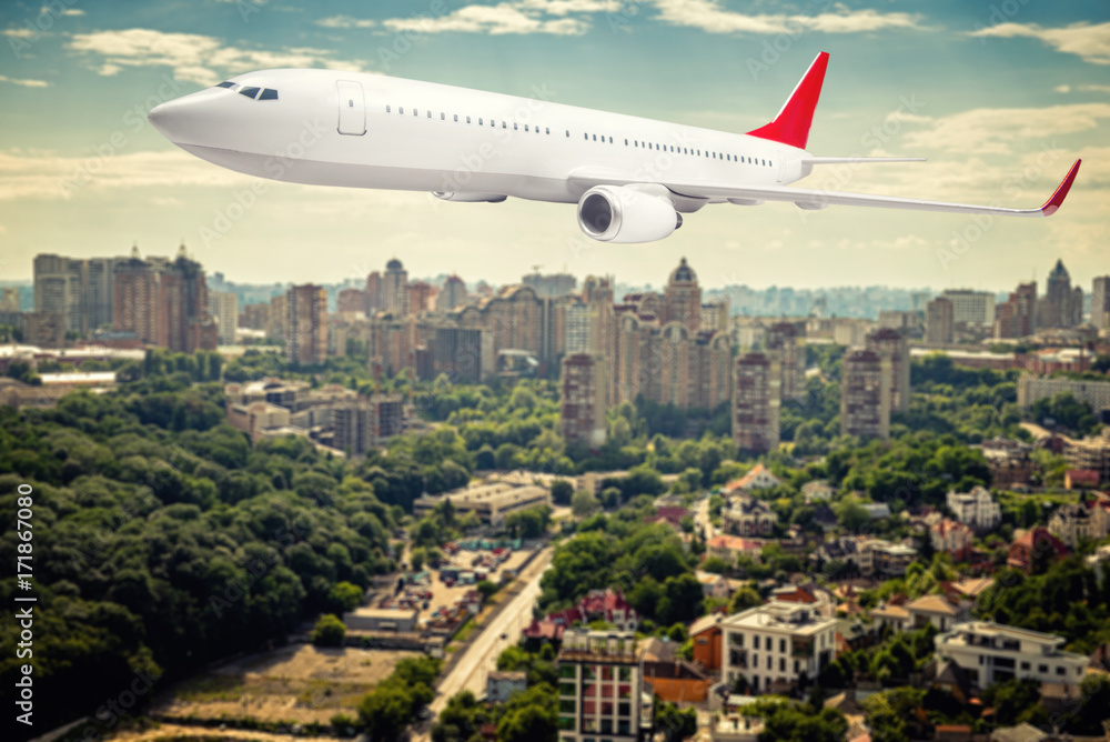 white passenger plane in the sky over the city white passenger plane in the sky over the city