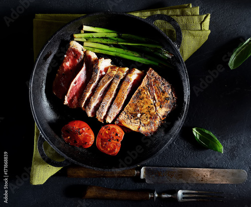 grilled steak and basil on a frying pan