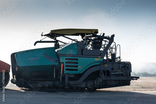Image of asphalt spreader machine with blue color,