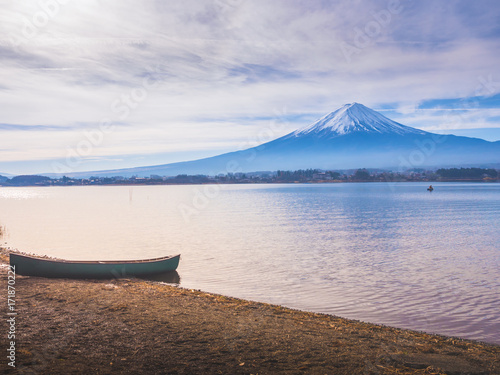 silhouette boat on ground at side of lake kawaguchi on morning time with fuji mountain background © tickcharoen04