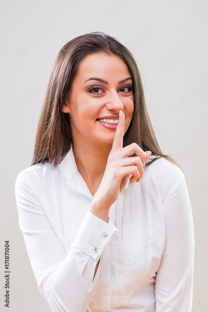 Portrait of young businesswoman who demands silence. Portrait of young businesswoman who demands silence.