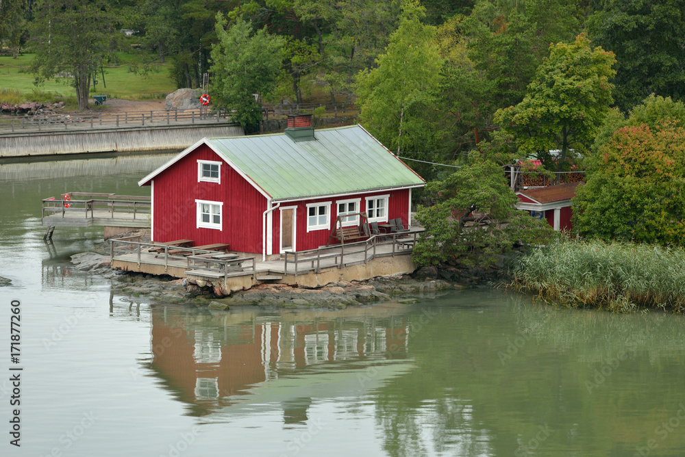 Traditional wooden red scandinavian house on shoreline of Turku archipelago island in Baltic Sea Traditional wooden red scandinavian house on shoreline of Turku archipelago island in Baltic Sea