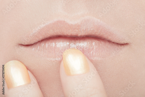 Woman mouth and golden nail polish beauty make up