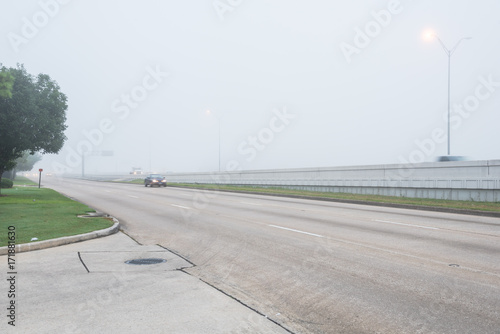 Tablou canvas Busy traffic on frontage road and freeway during foggy morning in Texas, USA