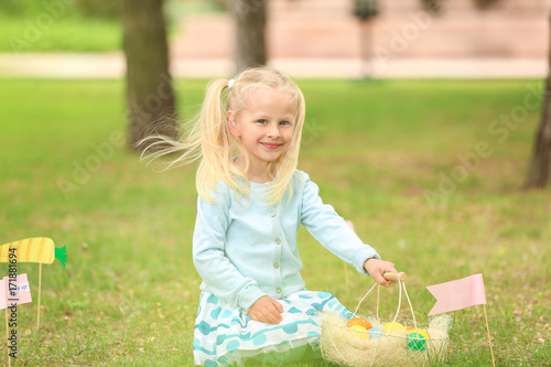 Cute little girl with baske...