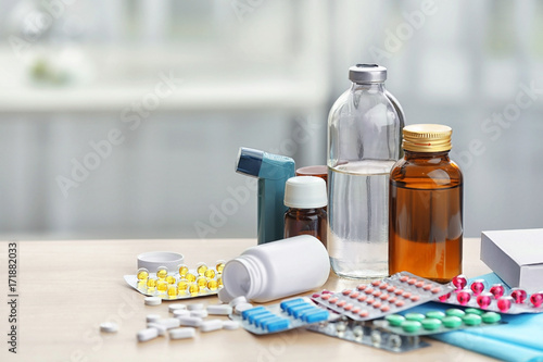 Different medicines and pills on wooden table