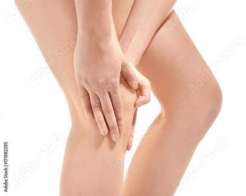 Young woman suffering from leg pain  on white background