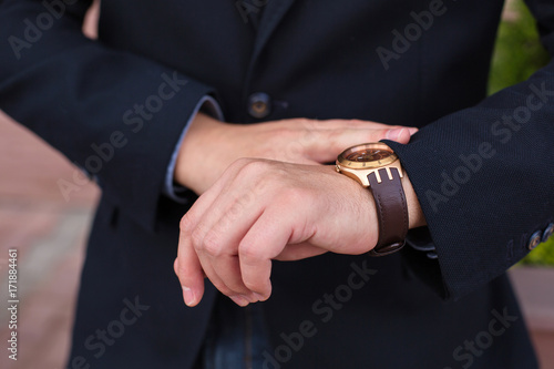 business man in dark suit check the time business success copy space