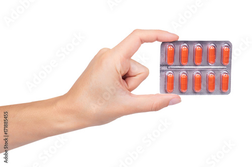 Capsules pills in hand isolated on white background
