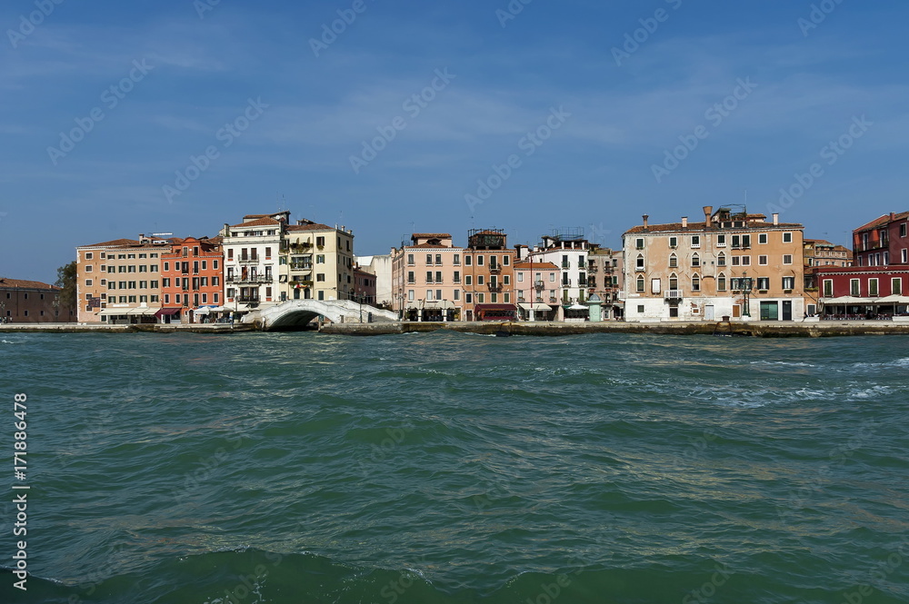 View from the sea at the residential district of waterside with bridge in Venezia, Venice, Italy, Europe 