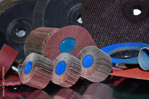 Obraz na płótnie Flap Wheel. A pile of color abrasive sandpaper for metal working