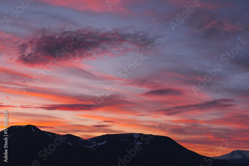 Landscape travel of a nature of a sunset sunrise with clouds in the mountains of Spitsbergen Svalbard near the Norwegian city Longyearbyen © bublik_polina