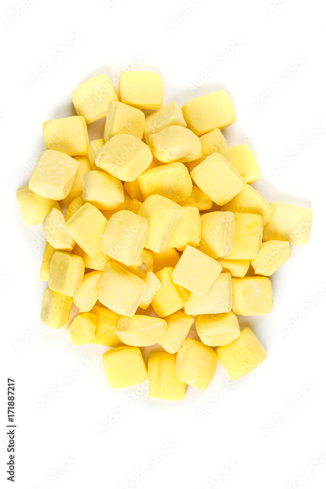 Pile of yellow mints isolated on a white background Pile of yellow mints isolated on a white background