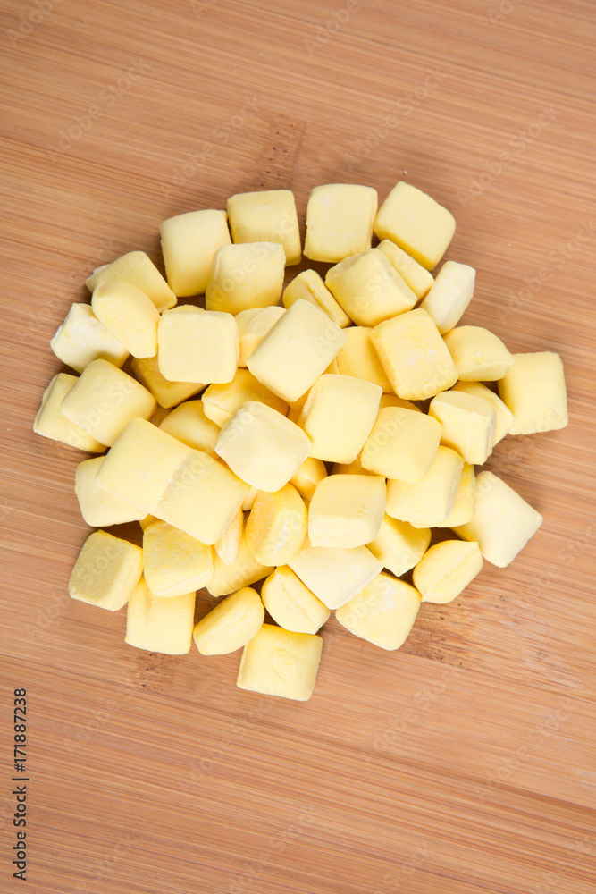Pile of yellow mints on a wood background Pile of yellow mints on a wood background