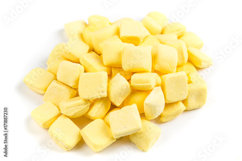 Pile of yellow mints isolated on a white background