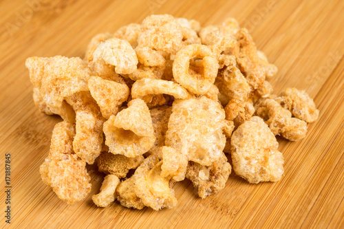 Pile of pork rinds on a wood background