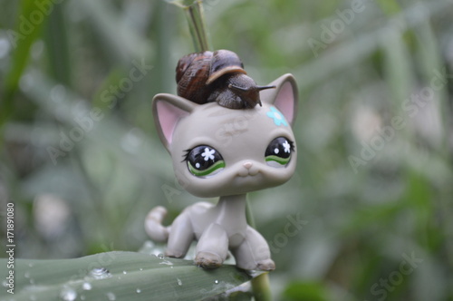 A toy cat with a snail