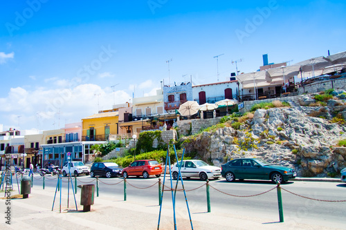 Fototapeta Naklejka Na Ścianę i Meble -  Charming colorful houses climbing up the hill on one of the streets of Rethymno. View from the seafront