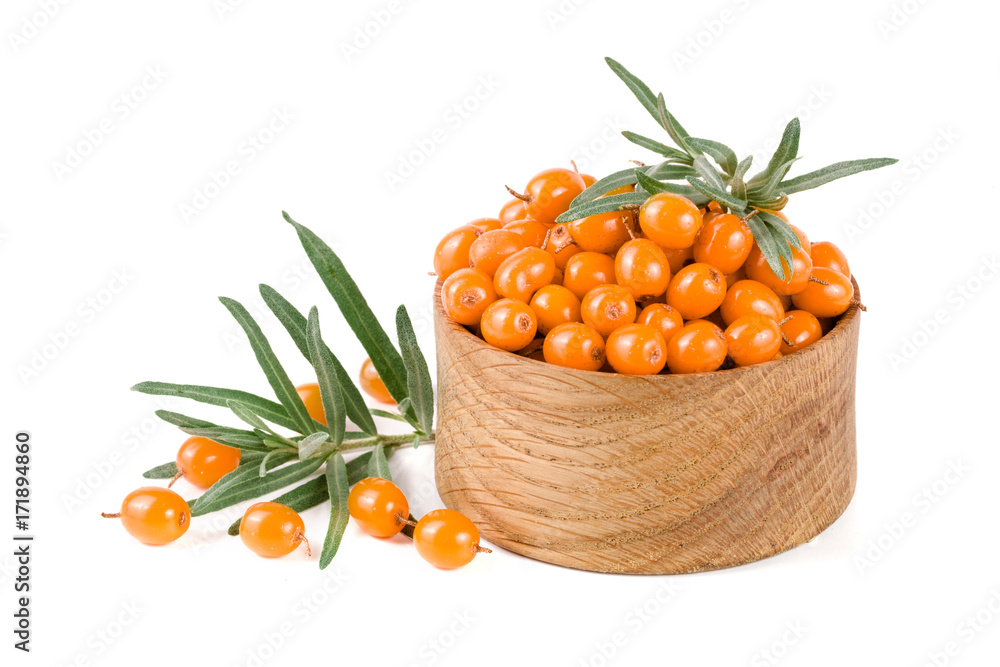 Sea buckthorn. Fresh ripe berry with leaves in a wooden bowl isolated on white background macro Sea buckthorn. Fresh ripe berry with leaves in a wooden bowl isolated on white background macro